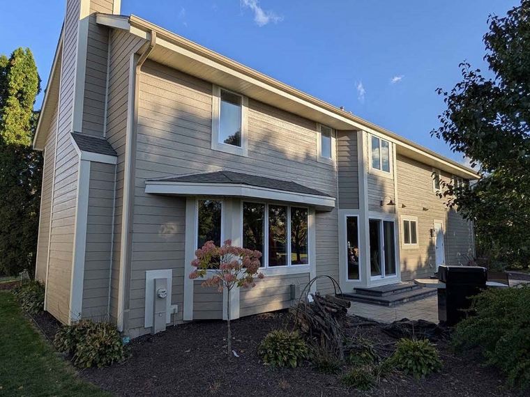 Completed siding project, rear view with landscaping