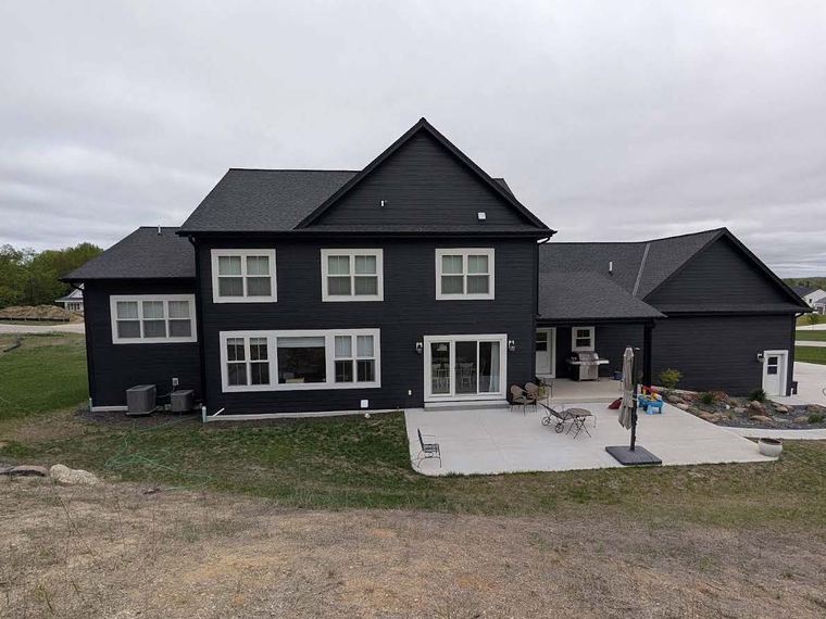 Completed home siding project with patio
